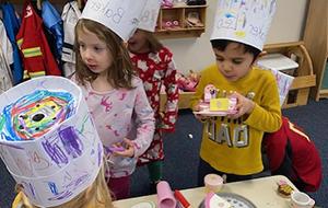 Kids playing bakery with chef hats on